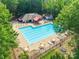 Aerial view of a community pool with lounge chairs and picnic tables at 8339 Hornwood Ct, Charlotte, NC 28215