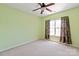 Bright bedroom with ceiling fan and carpet flooring at 8914 Landsdowne Ave, Harrisburg, NC 28075