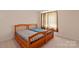 Cozy bedroom featuring two beds with warm lighting and patterned curtains for privacy at 8914 Landsdowne Ave, Harrisburg, NC 28075