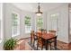 Charming breakfast nook with hardwood floors, ample windows, and a cozy dining set at 8914 Landsdowne Ave, Harrisburg, NC 28075
