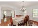 Elegant dining room with hardwood floors, chandelier, and access to other rooms at 8914 Landsdowne Ave, Harrisburg, NC 28075
