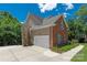 Charming home featuring brick and siding exterior, two-car garage, and well-maintained landscaping at 8914 Landsdowne Ave, Harrisburg, NC 28075