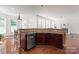 Bright kitchen with wooden floors, granite counters, and stainless steel dishwasher at 8914 Landsdowne Ave, Harrisburg, NC 28075