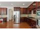Well-equipped kitchen with dark wood cabinets, stainless steel appliances, and a functional layout at 8914 Landsdowne Ave, Harrisburg, NC 28075