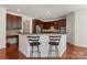 Spacious kitchen with granite countertops, stainless steel appliances, and stylish bar stools at 8914 Landsdowne Ave, Harrisburg, NC 28075