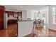 Modern kitchen featuring dark wood cabinets, stainless steel appliances, and a breakfast bar at 8914 Landsdowne Ave, Harrisburg, NC 28075