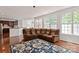 Open-concept living room featuring a large sectional sofa and abundant natural light from big windows at 8914 Landsdowne Ave, Harrisburg, NC 28075