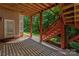A covered patio with red painted support columns and stairs leading to the backyard at 8914 Landsdowne Ave, Harrisburg, NC 28075