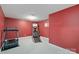 Carpeted recreation room featuring a treadmill and basketball hoop for fun and fitness at 8914 Landsdowne Ave, Harrisburg, NC 28075