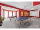 Spacious recreation room with a ping pong table, pool table, and access to natural light at 8914 Landsdowne Ave, Harrisburg, NC 28075