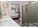 Bathroom with double sinks, and access to the primary bedroom, and a glass enclosed shower at 9034 Evercrisp Ln, Charlotte, NC 28215