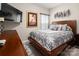 Comfortable primary bedroom features a patterned duvet cover and neutral decor at 9034 Evercrisp Ln, Charlotte, NC 28215