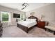 Comfortable bedroom with a ceiling fan, tv, and a large window with a view at 9034 Evercrisp Ln, Charlotte, NC 28215