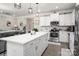 Open concept kitchen features a large island, stainless appliances, and modern lighting at 9034 Evercrisp Ln, Charlotte, NC 28215