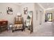 Cozy living room featuring stylish chair, modern art, and a full length mirror at 9034 Evercrisp Ln, Charlotte, NC 28215