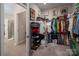 Large walk-in closet with custom shelving, and lots of storage and an entry into bathroom at 9034 Evercrisp Ln, Charlotte, NC 28215