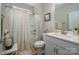 Bright bathroom featuring a shower-tub, white vanity with sink, and modern fixtures at 9034 Evercrisp Ln, Charlotte, NC 28215