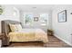 Cozy bedroom featuring hardwood floors, neutral tones, and natural light from two windows at 9109 Liberty Hill Dr, Mint Hill, NC 28227