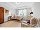 Inviting bedroom with tray ceiling, wood floors, natural light, and neutral decor at 9109 Liberty Hill Dr, Mint Hill, NC 28227