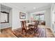 Spacious dining room with hardwood floors, ornate rug, and ample natural light at 9109 Liberty Hill Dr, Mint Hill, NC 28227