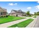 Charming home with brick accents, attached garage, and lush green lawn at 9109 Liberty Hill Dr, Mint Hill, NC 28227