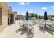 Inviting community pool area with tables, chairs, umbrellas and relaxing lounge area at 9109 Liberty Hill Dr, Mint Hill, NC 28227