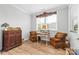 Cozy sitting room features hardwood floors, vintage furniture and bright window at 9109 Liberty Hill Dr, Mint Hill, NC 28227