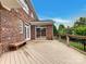 Large wooden deck with bench seating, perfect for enjoying the outdoors and overlooking the landscaped backyard at 1000 Sarandon Dr, Matthews, NC 28104