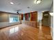 Bright bonus room with hardwood floors, built-in cabinetry, and large window at 1000 Sarandon Dr, Matthews, NC 28104