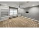 Bonus room featuring built-in shelving and storage with gray walls at 1000 Sarandon Dr, Matthews, NC 28104
