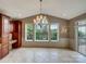 Inviting dining area with large windows, chandelier, and custom built-in cabinets at 1000 Sarandon Dr, Matthews, NC 28104