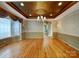 Dining room featuring elegant chandelier, decorative ceiling, and large window at 1000 Sarandon Dr, Matthews, NC 28104