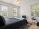 Bedroom with wood flooring, neutral walls, a ceiling fan, two bright windows and a modern rug at 1051 Streamlet Way, Monroe, NC 28110