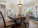 Cozy dining room features a classic chandelier and multiple windows for natural light at 1051 Streamlet Way, Monroe, NC 28110