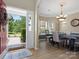 Inviting dining room featuring hardwood floors, elegant chandelier, and a large window for natural light at 1051 Streamlet Way, Monroe, NC 28110