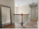 Upstairs hallway with wood floors, modern mirror and stylish chandelier at 1051 Streamlet Way, Monroe, NC 28110