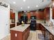 Well-equipped kitchen with an island, stainless steel appliances, and hardwood floors at 1051 Streamlet Way, Monroe, NC 28110