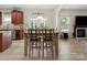 Open floor plan dining area with hardwood floors next to the fireplace at 1051 Streamlet Way, Monroe, NC 28110