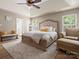 Spacious main bedroom with trey ceilings, hardwood floors, large windows and a comfortable seating area at 1051 Streamlet Way, Monroe, NC 28110