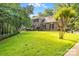 Charming two-story brick home with lush green lawn, mature trees, and classic architectural details at 1134 Willow Oaks Trl, Matthews, NC 28104