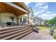 Multi-level backyard deck with comfortable seating, a covered patio, and a bricked firepit area at 1147 Anduin Falls Dr, Charlotte, NC 28269