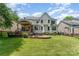 Spacious backyard with a large deck, covered patio, and well-manicured lawn at 1147 Anduin Falls Dr, Charlotte, NC 28269