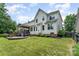 Landscaped backyard featuring a paver patio, tiered deck, and mature trees at 1147 Anduin Falls Dr, Charlotte, NC 28269
