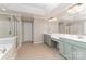 Bright bathroom featuring a double sink vanity, a glass-enclosed shower, and a separate soaking tub at 1147 Anduin Falls Dr, Charlotte, NC 28269