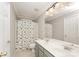 Bathroom with a double sink vanity, a large mirror, and a shower curtain featuring a dinosaur theme at 1147 Anduin Falls Dr, Charlotte, NC 28269