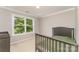 Cozy bedroom with a crib, a changing table, a large window and neutral carpeting at 1147 Anduin Falls Dr, Charlotte, NC 28269