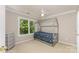 Bright bedroom with a whimsical house frame bed and large window overlooking lush greenery at 1147 Anduin Falls Dr, Charlotte, NC 28269