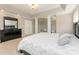 Spacious bedroom with tray ceiling, white columns and a large bed with decorative pillows at 1147 Anduin Falls Dr, Charlotte, NC 28269