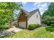 Exterior side view showing a two-story home with attached garage and well-maintained lawn at 1147 Anduin Falls Dr, Charlotte, NC 28269