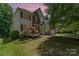 Charming two-story home features a blend of brick and siding, complemented by well-manicured landscaping and mature trees at 1147 Anduin Falls Dr, Charlotte, NC 28269
